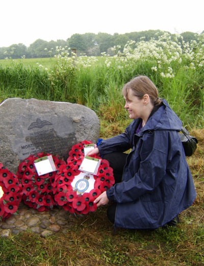 Hilary Mortimer, a descendant of Sgt Ellis laying a Poppy wreath on the memorial